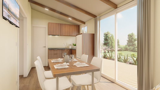 Vista interior del Living comedor de una casa tiny Prewasi con árboles afuera